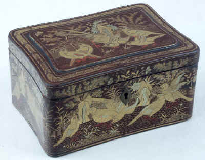 A Chinese export lacquer tea caddy in reddish earth colored lacquer having rounded corners decorated with two colors of gold depicting groups of birds highlighted in red lacquer. Circa 1840