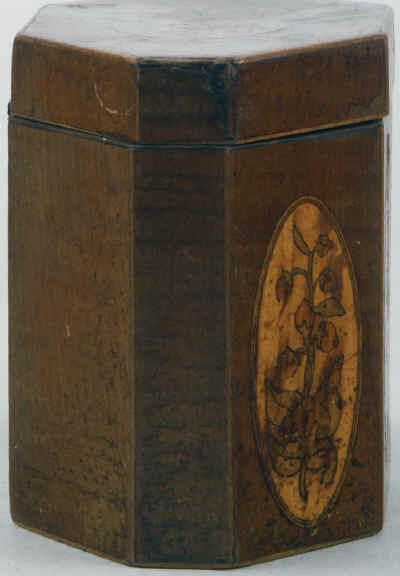 An Octagonal Caddy veneered in harewood and inlaid with oval marquetry panels depicting country flowers. Circa 1790