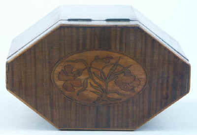 An Octagonal Caddy veneered in harewood and inlaid with oval marquetry panels depicting country flowers. Circa 1790