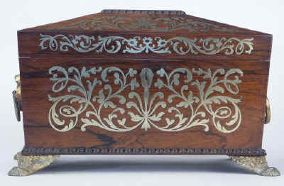 A Rosewood three compartment  brass Inlaid Tea Chest with gadrooned framings having twin lift-out  wooden canisters flanking a cut crystal bowl standing on embossed gilded brass feet and with drop handles, Circa 1825.