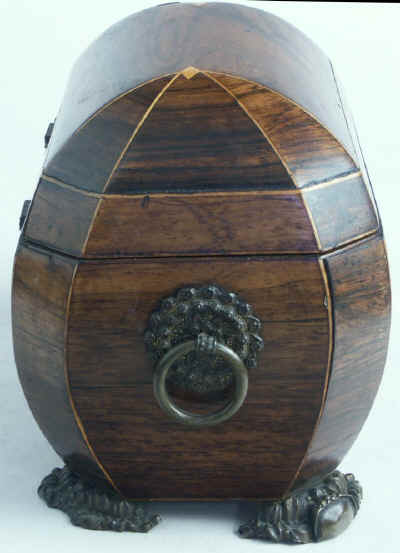 A bombe-shaped Regency  twin compartment tea caddy veneered in rosewood strung with boxwood with embossed feet and handles. Circa 1820.