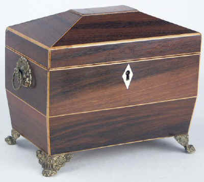 A  Regency shaped rosewood caddy with pyramided top with  brass  side handlesand feet Circa 1830