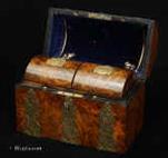 742TC: Victorian Burr Walnut veneered two compartment Tea Caddy on a mahogany structure with engraved and pierced brass mounts and trick opening to the tea canisters. The burr walnut is exceptionally intricately figured. The straps of brass are pierced and finely chased  in the neo-gothic style. The return for inspiration to an earlier era, which was seen as more purely English, was a symptom of the renewed sense of patriotism, characteristic of the Victorian era. Circa 1880 