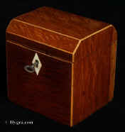 744TC: Partridge wood single compartment tea caddy strung with boxwood and opening to a lidded tea compartment. The top is canted to the front and back. The interior lid is of maple. Both the inside of the lid and the inside of the caddy retains a lot of the original lining. Circa 1790 