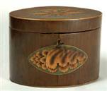 TC103: An oval tea caddy veneered in hairwood with marquetry ovalhot sand shaded  inset decoration.  The symmetry of the decoration place the caddy in the neo-classical tradition of the late 18th century. The decoration is both robust and finely executed, making this an excellent example of the genre. Circa:  1790.