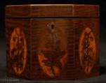 TC131: An Octagonal Caddy veneered in harewood having boxwood stringing and inlaid with oval marquetry panels depicting country flowers. Circa 1790.
