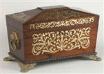 TC133: A Rosewood three compartment  brass Inlaid Tea Chest with gadrooned framings having twin lift-out  wooden canisters flanking a cut crystal bowl standing on embossed gilded brass feet and with drop handles, Circa 1825.