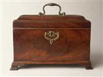 TC137: A flame mahogany tea chest of traditional Chippendale form having fretted brass escutcheon and top carrying handle with a sliding side revealing a secret spoon drawer and standing on bracket feet. Circa 1770.