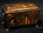 TC139: A polychromed tea chest painted in a fluid hand with an exotic scene. The elongated figures, the inverted flower hats, and the lightness of execution suggest a knowledge of later more refined chinoiserie design. The top is similarly decorated gently built up into three dimensions using white size and fine plaster gesso  Circa 1820.