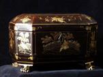 TC145: A Chinese export lacquer tea chest with gold decoration containing two metal tea canisters. It stands on carved wooden feet in the shape of paws.  Circa 1850.