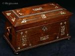 TC426:  Tea chest in highly figured rosewood of architectural form inlaid with mother of pearl  which depicts stylized flora and fauna,  the chest standing on turned rosewood feet having turned drop handles. Inside the tea chest there are two liftout hinged canisters (retaining some of their original leading) and a particularly fine cut lead crystal bowl. Circa 1835-40. 