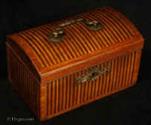 TC537: 18th century tea caddy with domed top  the oak carcass veneered with a parquetry of rosewood and satinwood  in alternating stripes. framed by a cross-banding in kingwood.  The escutcheon is gilded bronze.  The inside is lined with lead foil. There is a single lid which would sit on the tea in the 18th century manner. Circa 1770. 