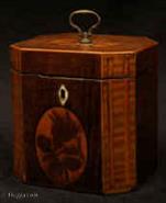 TC551:  A  fine one compartment inlaid George III Tea Caddy circa 1790  of octagonal form veneered in various woods including stained maple (harewood).  The hinged top and large sides  inlaid with marquetry medallions.  The front cartouche depicts a rose in bud. The top a pattera executed using the hot sand method.   The canted corners have blind flute inlay.
