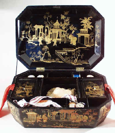 large Chinese export lacquer Chinese sewing box, decorated all over with scenes of oriental figures in gardens in raised gilded lacquer. Circa 1840. 