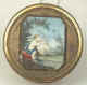 An exquisite yellow horn and transparent horn snuff box framed in a gold mount. Sandwiched between two layers of horn on the top is a painting of Cupid shooting an arrow, while a dove flies upwards carrying a heart. The painting is beautifully executed with the meticulous care of a miniaturist. It id framed in a gilded design of leaves.  There is an engraved pattern all around with hints which point to worn gilding. French, circa 1790. 