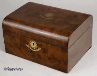 JB231: A dome top figured walnut box with brass escutcheon and accents retaining its original green satin padding to the lid and having a refitted liftout tray, circa 1890. Enlarge Picture