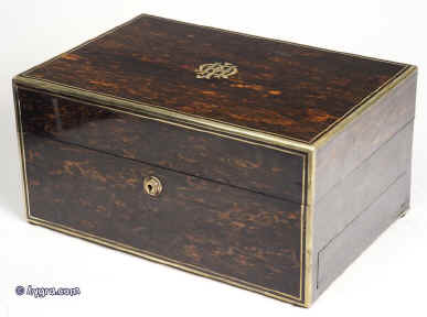 JB308: Antique box veneered in strongly figured  coromandel, with brass edging, central  inlaid ornate initials. working Bramah lock and key. The box is  high quality,  which continues into the interior. It is lined in velvet,  and  embossed leather. It has a lift-out tray and sprung drawer elaborately fitted for jewelry.  Circa 1840. Enlarge Picture