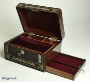 A rosewood veneered box, inlaid with mother of pearl  and white metal in a stylised pattern,  having a replacement velvet lined liftout tray and a separately locked side drawer circa 1840. Enlarge Picture