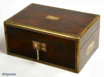 A brass edged rosewood box having two velvet lined liftout trays of rosewood construction and document wallet with high security Chubb detector lock. The box is beautifully constructed in highly figured rosewood having solid rounded brass edgings and inset handles. The ruched and plain velvet  are all original. Circa 1840. Enlarge Picture