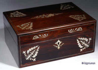 SB123: Antique figured rosewood box with dramatic contrasting mother of pearl inlay depicting native plants, the box opening to a fitted inside with liftout tray with divisions for sewing. The tray is covered in its original 19th C paper and has supplementary lids covered in blue silk. The box has a rounded filet of solid rosewood let into the edges. All the veneers at this period are saw cut and about 1mm thick. Circa 1835. Enlarge Picture