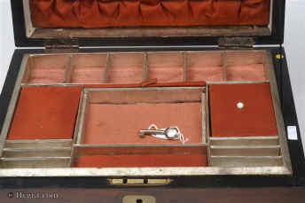 SB456: Walnut veneered box circa 1890. A sewing box veneered in walnut, its charm being its very simplicity. The central plaque an escutcheon are brass. The tray is original as is the ruched top and covers. The lighter
            coloured lining silk is later. The box has its own social history as it was given as a prize. Working lock and key.  Enlarge Picture