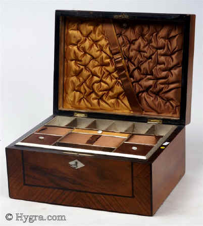 SB460: Walnut veneered box strikingly framed circa 1880. A box veneered in walnut and framed in figured walnut cut so as to emphasise the slanting stripes. It is further accented with separating black lines. The two tone interior is original and hardly shows any signs of wear. Working lock and key.
  Enlarge Picture