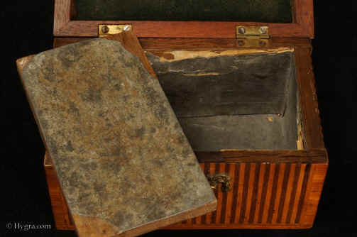 TC537:18th century tea caddy with domed top  the oak carcass veneered with a parquetry of rosewood and satinwood  in alternating stripes. framed by a crossbanding in kingwood.  The escutcheon is gilded bronze.  The inside is lined with lead foil. There is a single lid which would sit on the tea in the 18th century manner. Circa 1770. Enlarge Picture