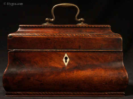 TC572: A mahogany veneered tea chest of bombe shape with rope twist banding, containing three lidded metal canisters.  Note the exceptionally good patina.  A tea chest of similar form was auctioned in 1984 bearing the label Braithwaite. This name is consistent with recorded makers in London and York at the correct date. Note the surviving traces of leading on the sides of the wooden lid.  Circa 1760-70. Enlarge Picture