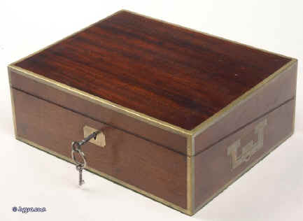WB152: Regency brass edged  mahogany  writing box  countersunk brass handles opening to green baize writing surface and compartments for pens and inkwells, having compartments for paper under the flaps. The box retains two original inkwells one with its original silver plated top. circa 1800. Enlarge Picture