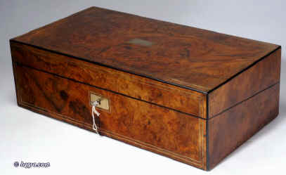 WB170: Burr walnut writing box with rounded ebony edging brass inlaid lines opening to an embossed  leather covered writing surface with compartments for storing paper under. There are also places for pens and ink bottles. Circa 1860. Enlarge Picture