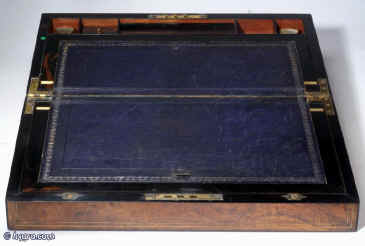 WB170: Burr walnut writing box with rounded ebony edging brass inlaid lines opening to an embossed  leather covered writing surface with compartments for storing paper under. There are also places for pens and ink bottles. Circa 1860.  Enlarge Picture
