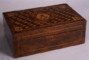 An extremely rare writing box, made as a special commission, featuring Masonic symbols on a parquetry background.Circa 1840 Enlarge Picture