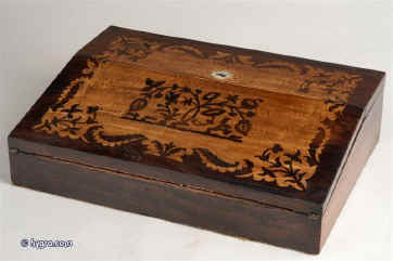Antique writing slope/ lap desk, the top decorated with marquetry in contrasting rosewood and birds eye maple  depicting stylized themes from nature, opening down to reveal an embossed royal purple velvet writing surface and compartments for pens and writing instruments. There is a compartment for holding paper under the flap circa 1840 Enlarge Picture