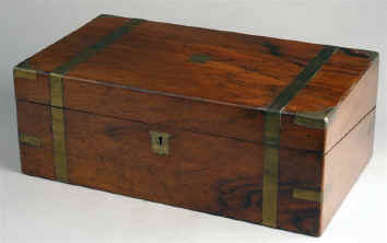 A brass bound walnut veneered writing box  opening to an embossed  leather writing surface and compartments for writing implements and paper. circa 1860 Enlarge Picture