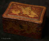 TC130: A Chinese export lacquer tea caddy in reddish earth colored lacquer having rounded corners decorated with two colors of gold depicting groups of birds highlighted in red lacquer. Circa 1840. Enlarge Picture