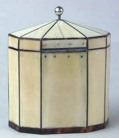 Hygra: A ten sided tortoiseshell strung ivory  tea caddy with a pyramid top  having a silver ball finial,   a silver escutcheon, and silver plaque on the front encircled with pique point. Circa 1790.