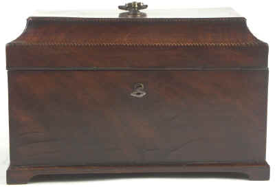 A flame mahogany tea chest of traditional Chippendale form with cavetto molding to the top and edged subtly with rope twist banding having brass edge escutcheon and Dutch drop handle and containing three tinned ferrous metal lift out containers. Circa 1775.  mahchcan03.jpg (19845 bytes)