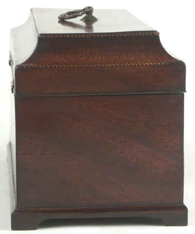 A flame mahogany tea chest of traditional Chippendale form with cavetto molding to the top and edged subtly with rope twist banding having brass edge escutcheon and Dutch drop handle and containing three tinned ferrous metal lift out containers. Circa 1775. mahchcan04.jpg (34754 bytes)
