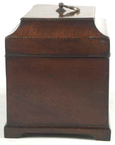 A flame mahogany tea chest of traditional Chippendale form with cavetto molding to the top and edged subtly with rope twist banding having brass edge escutcheon and Dutch drop handle and containing three tinned ferrous metal lift out containers. Circa 1775. mahchcan06.jpg (37457 bytes)