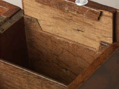 A flame mahogany tea chest of traditional Chippendale form having fretted brass escutcheon and top carrying handle with a sliding side revealing a secret spoon drawer and standing on bracket feet. Circa 1770