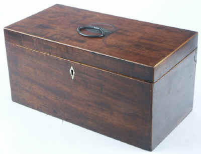 Hygra: Georgian mahogany three compartment tea chest having twin oval toped lift-out wooden canisters flanking a cut glass bowl. Circa 1790. 