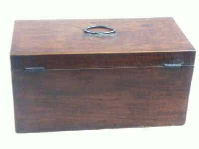 Hygra: Georgian mahogany three compartment tea chest having twin oval toped lift-out wooden canisters flanking a cut glass bowl. Circa 1790. 