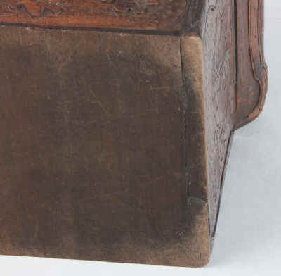 A tea caddy of cube form with the top and sides deeply carved depicting trailing oak leaves