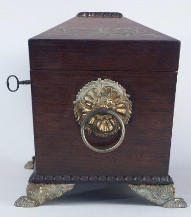 A Rosewood three compartment  brass Inlaid Tea Chest with gadrooned framings having twin lift-out  wooden canisters flanking a cut crystal bowl standing on embossed gilded brass feet and with drop handles, Circa 1825.