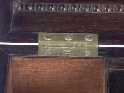 A Rosewood three compartment  brass Inlaid Tea Chest with gadrooned framings having twin lift-out  wooden canisters flanking a cut crystal bowl standing on embossed gilded brass feet and with drop handles, Circa 1825.