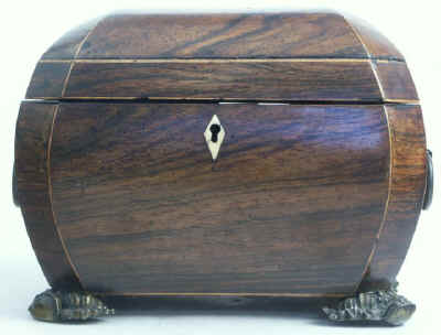 A bombe-shaped Regency  twin compartment tea caddy veneered in rosewood strung with boxwood with embossed feet and handles. Circa 1820.