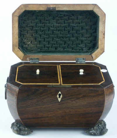 A bombe-shaped Regency  twin compartment tea caddy veneered in rosewood strung with boxwood with embossed feet and handles. Circa 1820.