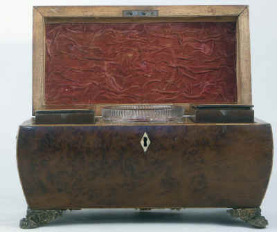 A burr yew  three compartment tea caddy/chest of bombe shape, pyramided top with gilded brass drop handleshandles and feet.