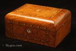 SB682: Antique inlaid figured walnut box with domed top opening to a ruched satin lined lid and a compartmentalized lift-out tray  fitted for sewing with supplementary lids Circa 1870.  