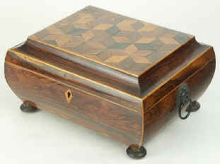  A bombe shaped box, the main body veneered in rosewood, the top in parquetry. This box is an excellent example of early nineteenth century Tunbridge ware work. During the first decades of the nineteenth century, Tunbridge ware developed a distinctive style, which utilised the beauty of the different woods, both local and imported, available to the makers working in the area of Tunbridge Wells in  Kent. By careful juxtaposition of figure, cut, colour and even peculiarity, such as a fungal attack, the artist/craftsmen, celebrated the richness of the natural world by displaying it on impeccably structured boxes. Circa 1815